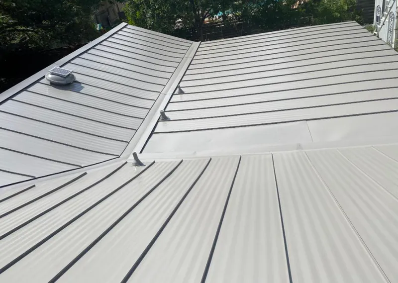 Solar attic fan installed on a metal roof for Roof Ventilation in Fort Scott